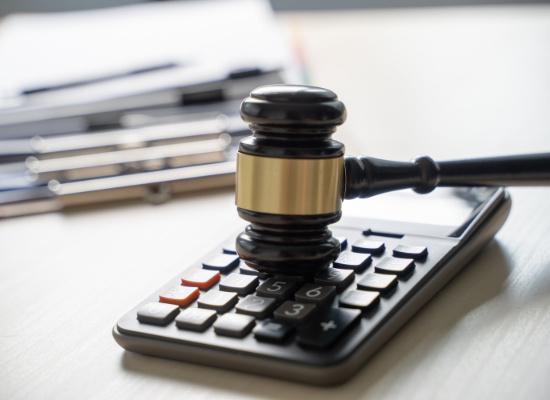 Gavel and calculator on desk Gavel and calculator on desk